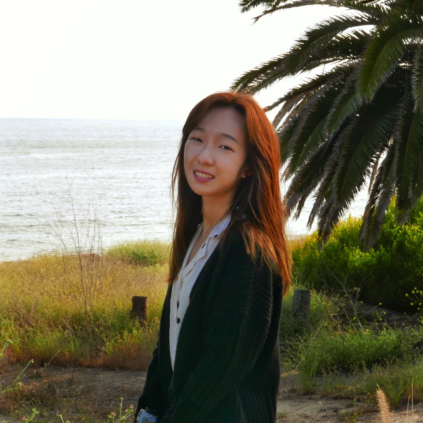 Xinchang smiling outdoors